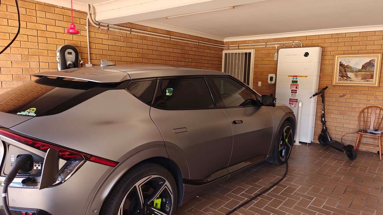 A Kia EV6 plugged in and charging inside a garage in Brisbane, QLD