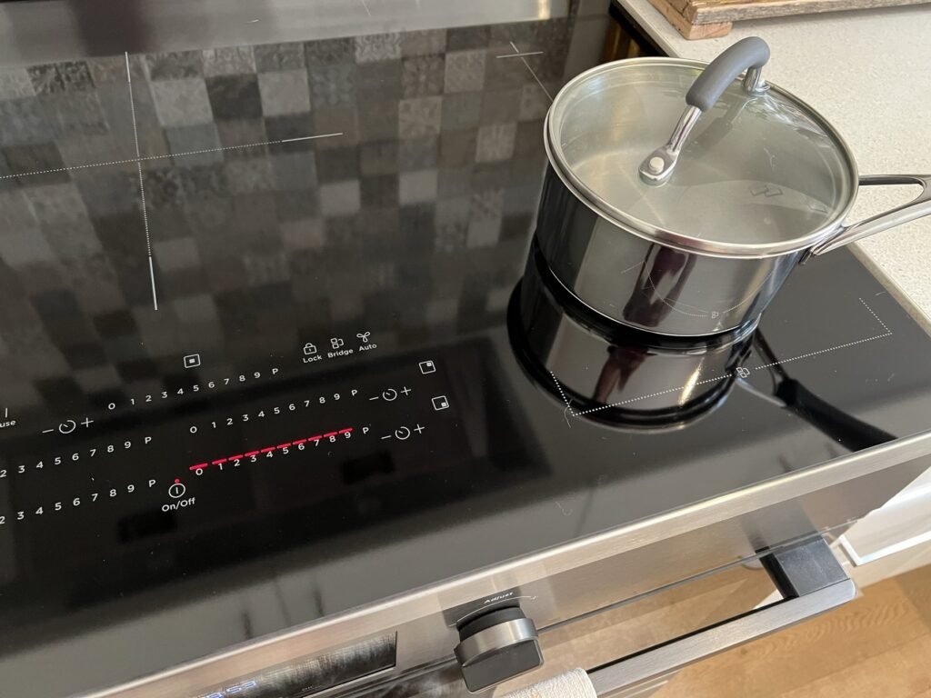 Saucepan on a black Westinghouse induction cooktop with its touch controls lit red